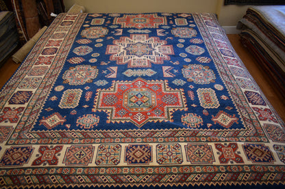 Afghan Kazak Rug, 9' x 11'8", in blue, ivory, navy and red